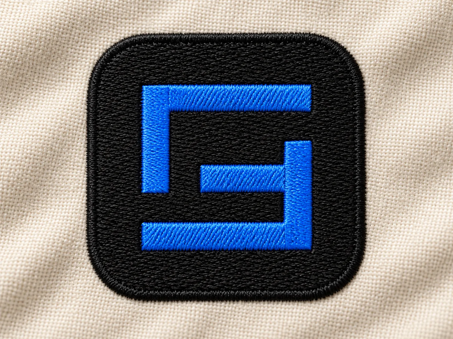 Photorealistic Embroidered Logo Mockup on Fabric AI-generated design created with this prompt